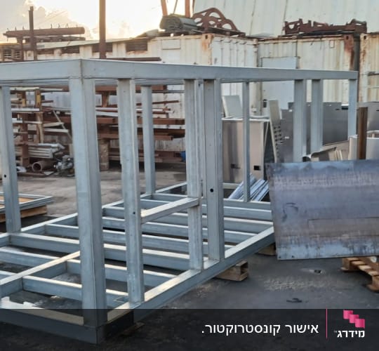 מסגרת מתכת גדולה באתר בנייה עם לוחות עץ וברזל